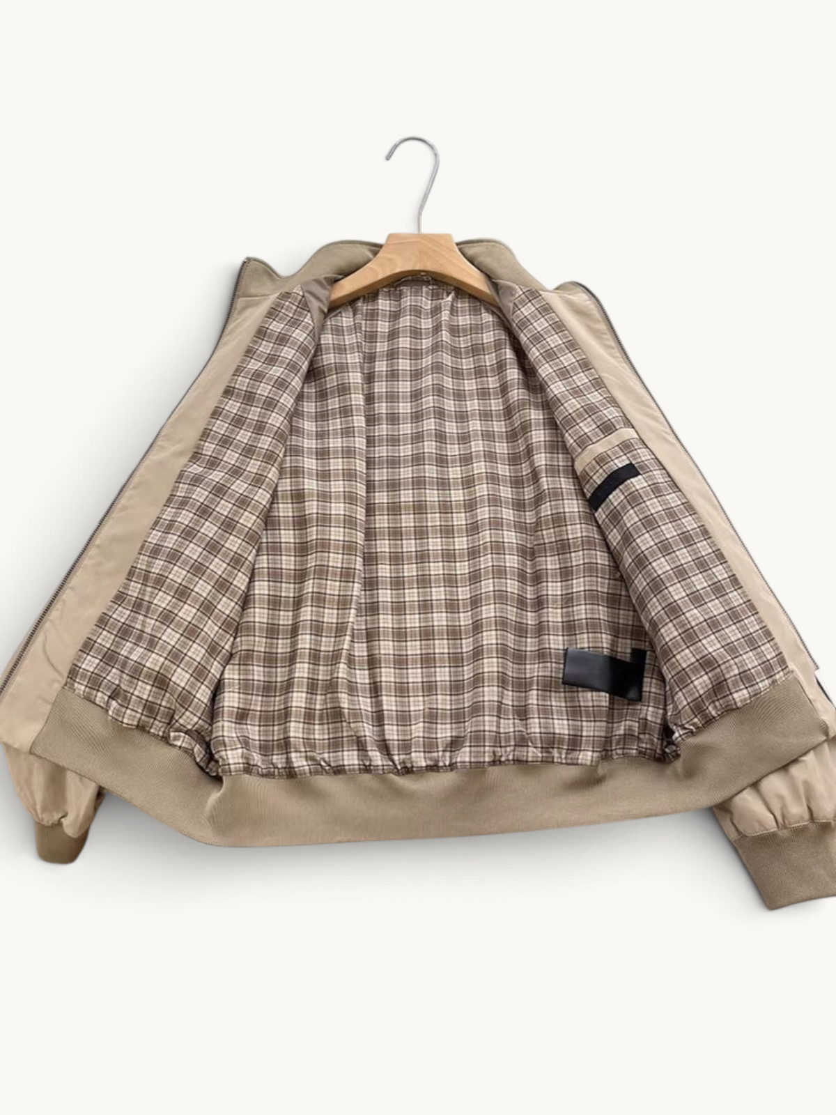 By Old Money beige lightweight blouson jacket with a brown and white plaid interior lining and ribbed cuffs