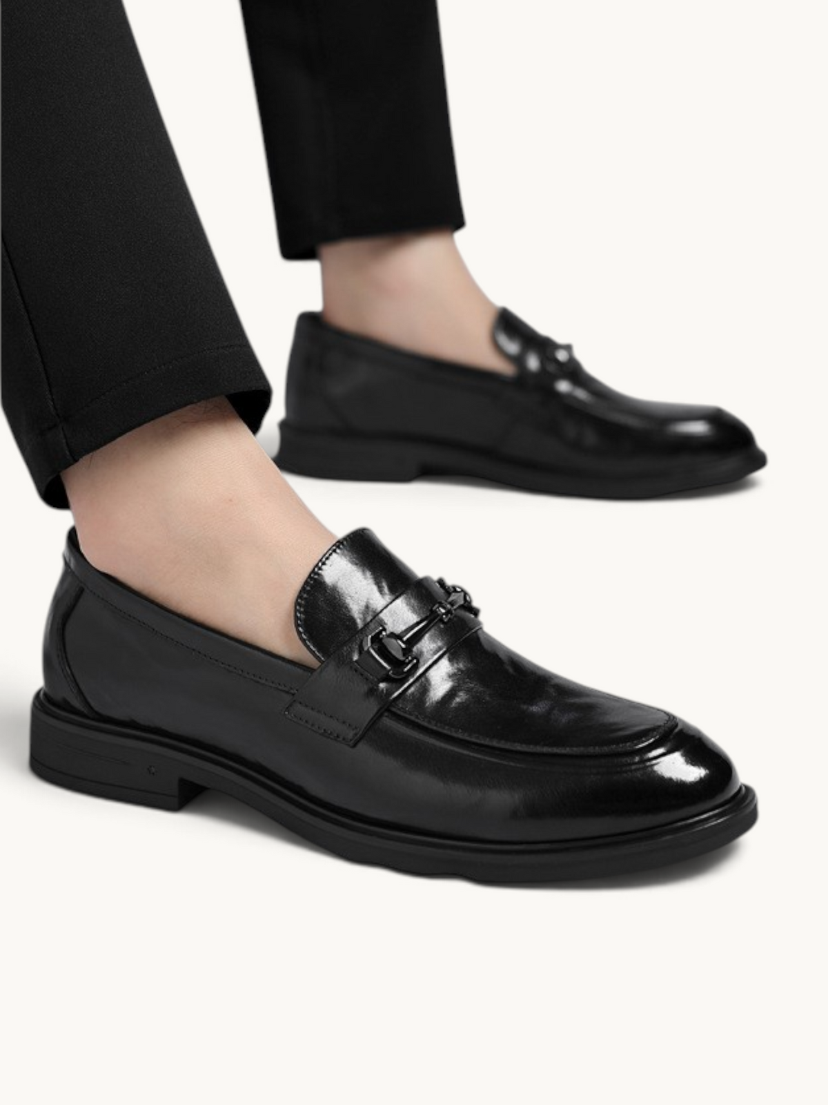 By Old Money black leather loafers with a polished finish and metal bit detail worn with black trousers