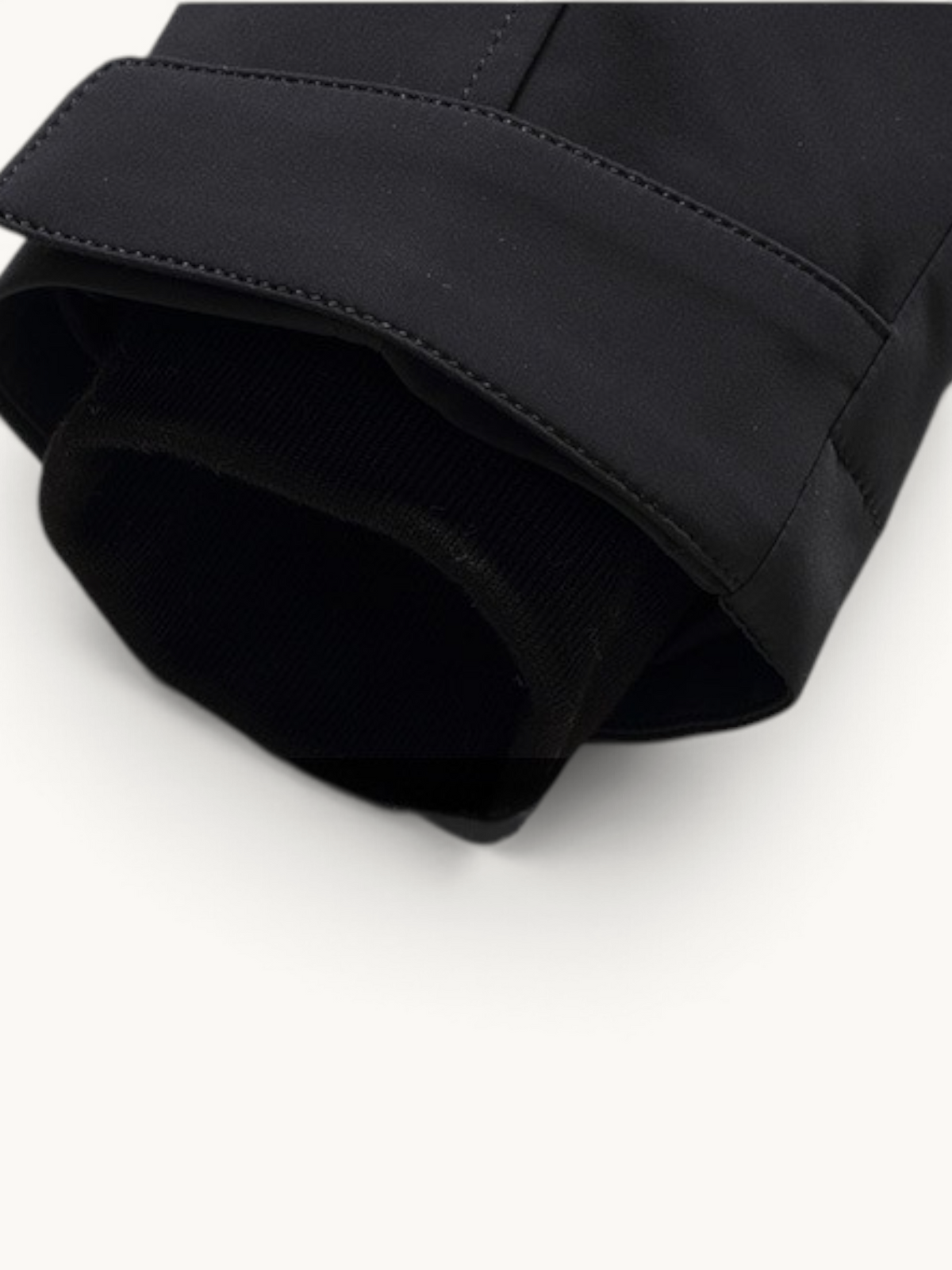 By Old Money black parka sleeve detail featuring a ribbed inner cuff and adjustable velcro strap closure.