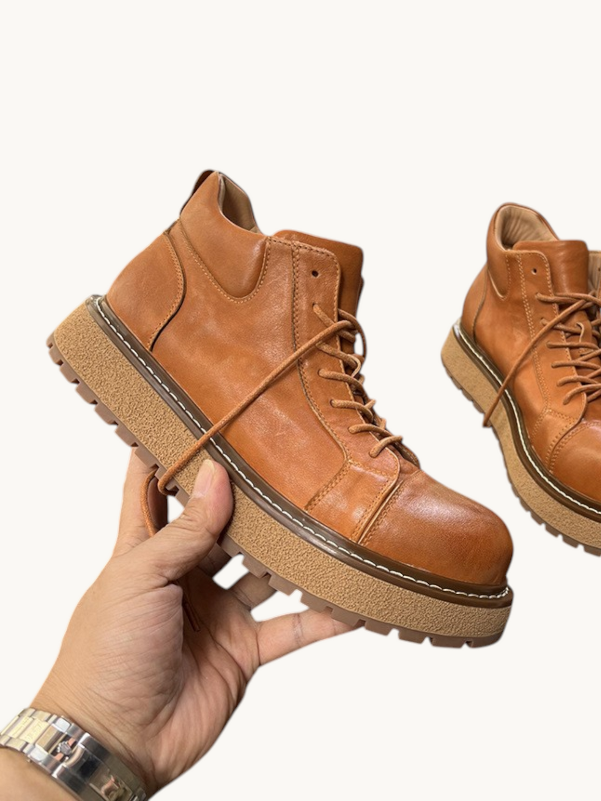By Old Money tan full-grain leather work boots with a thick lug sole and mid-high ankle support.