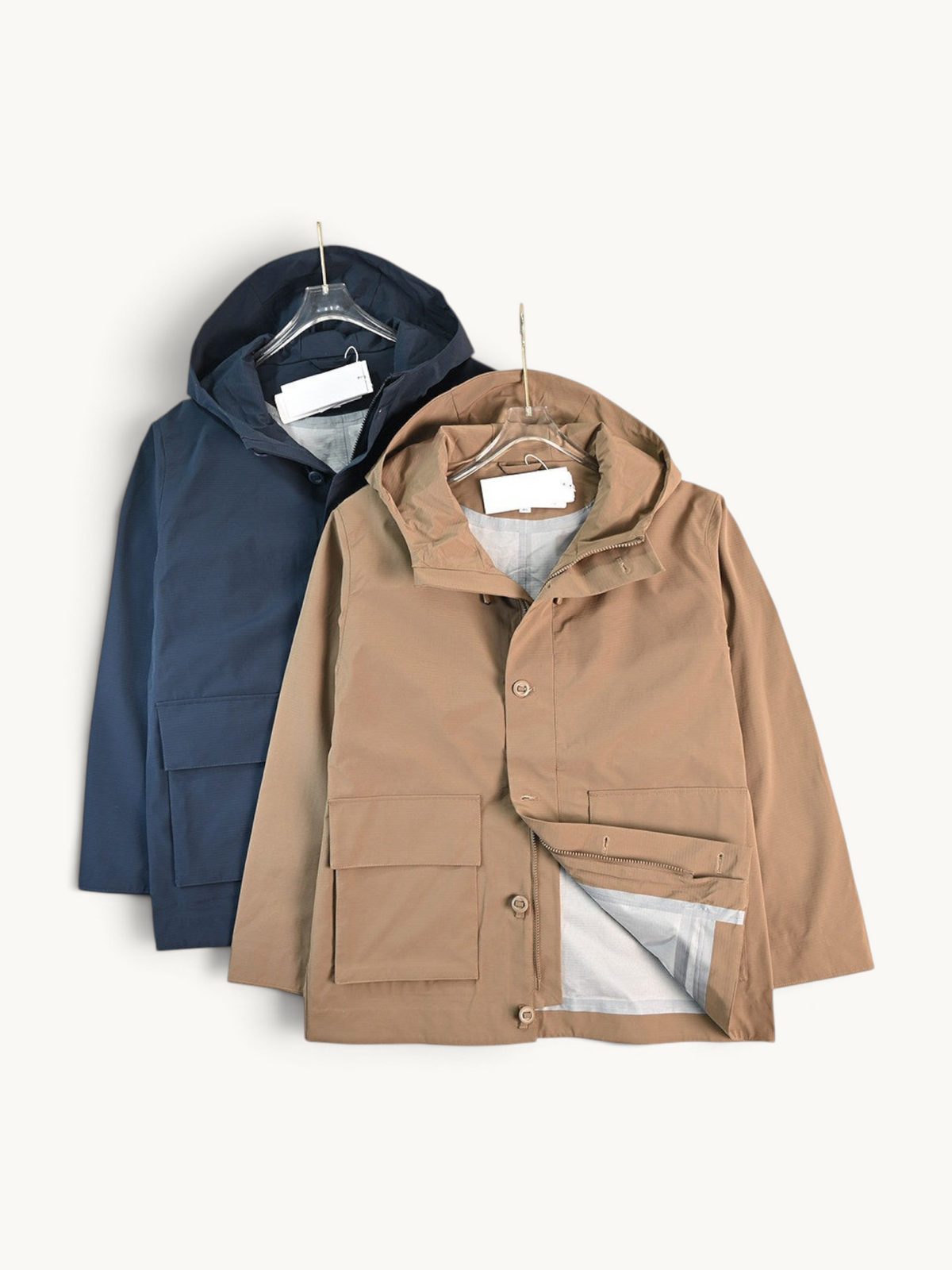 By Old Money water-repellent hooded jackets in navy and tan with large flap pockets and zip-snap closures