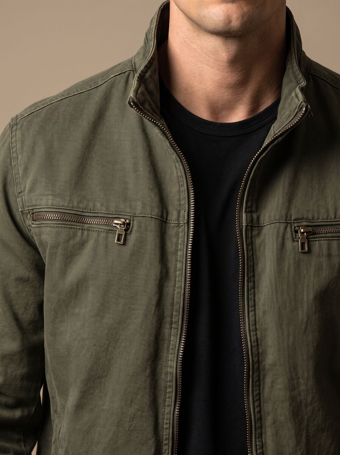 Détail du col montant et des poches zippées, blouson vert armée