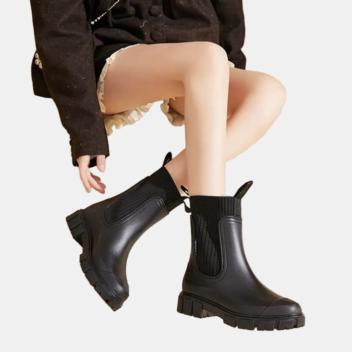 Bottines de pluie noires à tirettes, portées avec un short, vue assise