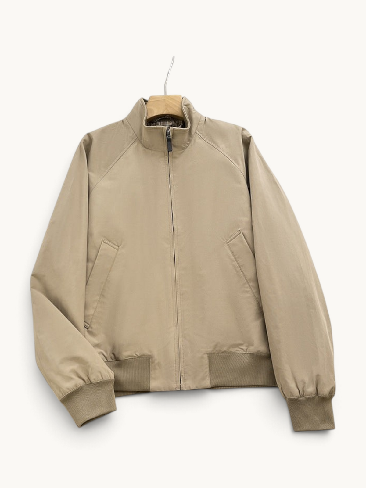 By Old Money beige lightweight blouson jacket with a stand-up collar, zip closure, and ribbed cuffs.