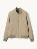 By Old Money beige lightweight blouson jacket with a stand-up collar, zip closure, and ribbed cuffs.