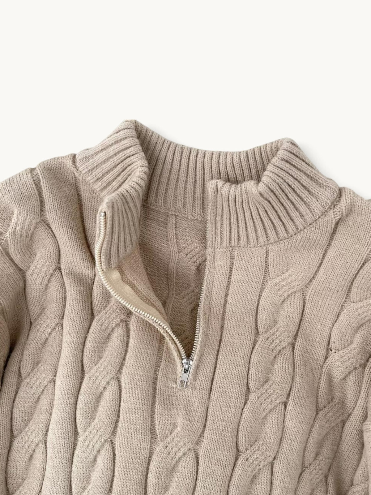 By Old Money beige cable knit sweater with a high collar and silver half-zip detail