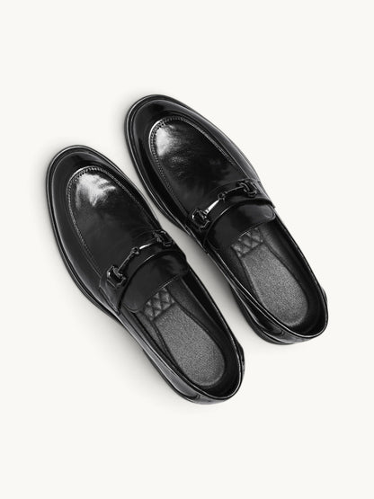 By Old Money black leather loafers with a polished finish and metal horsebit detail, viewed from above.