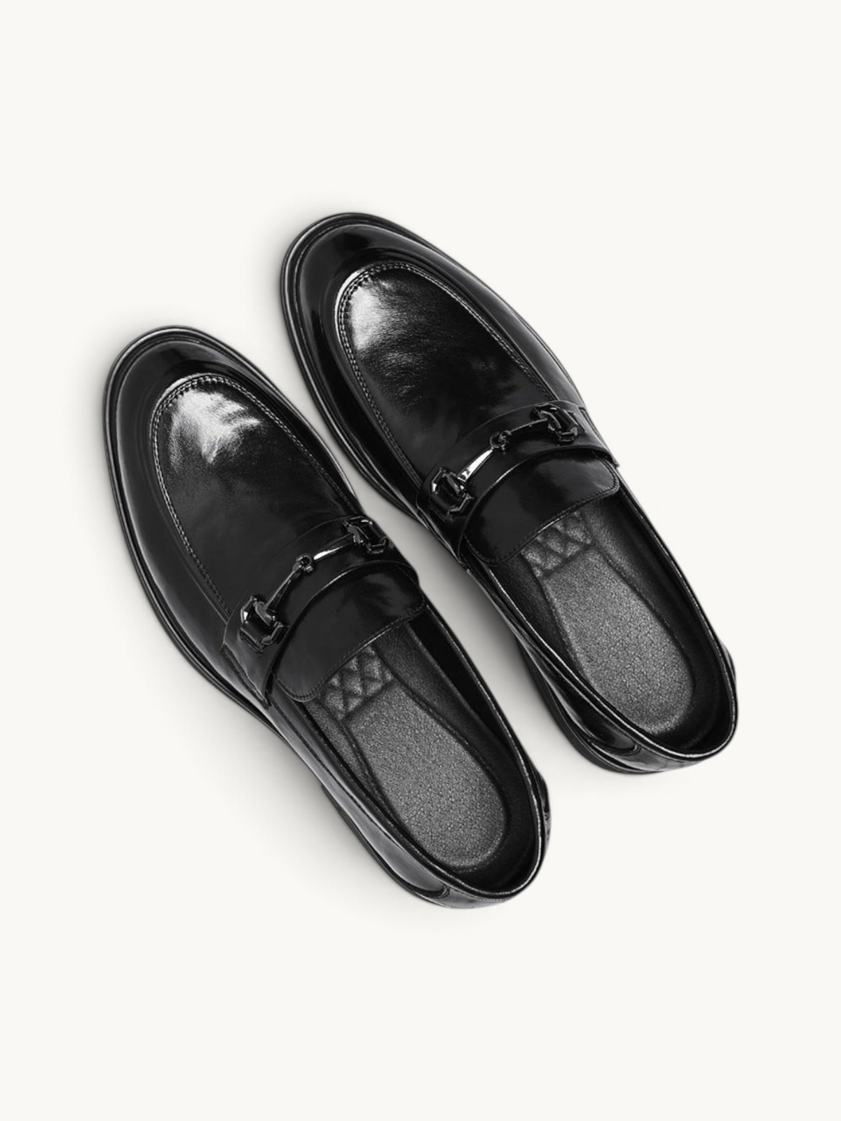 By Old Money black leather loafers with a polished finish and metal horsebit detail, viewed from above.