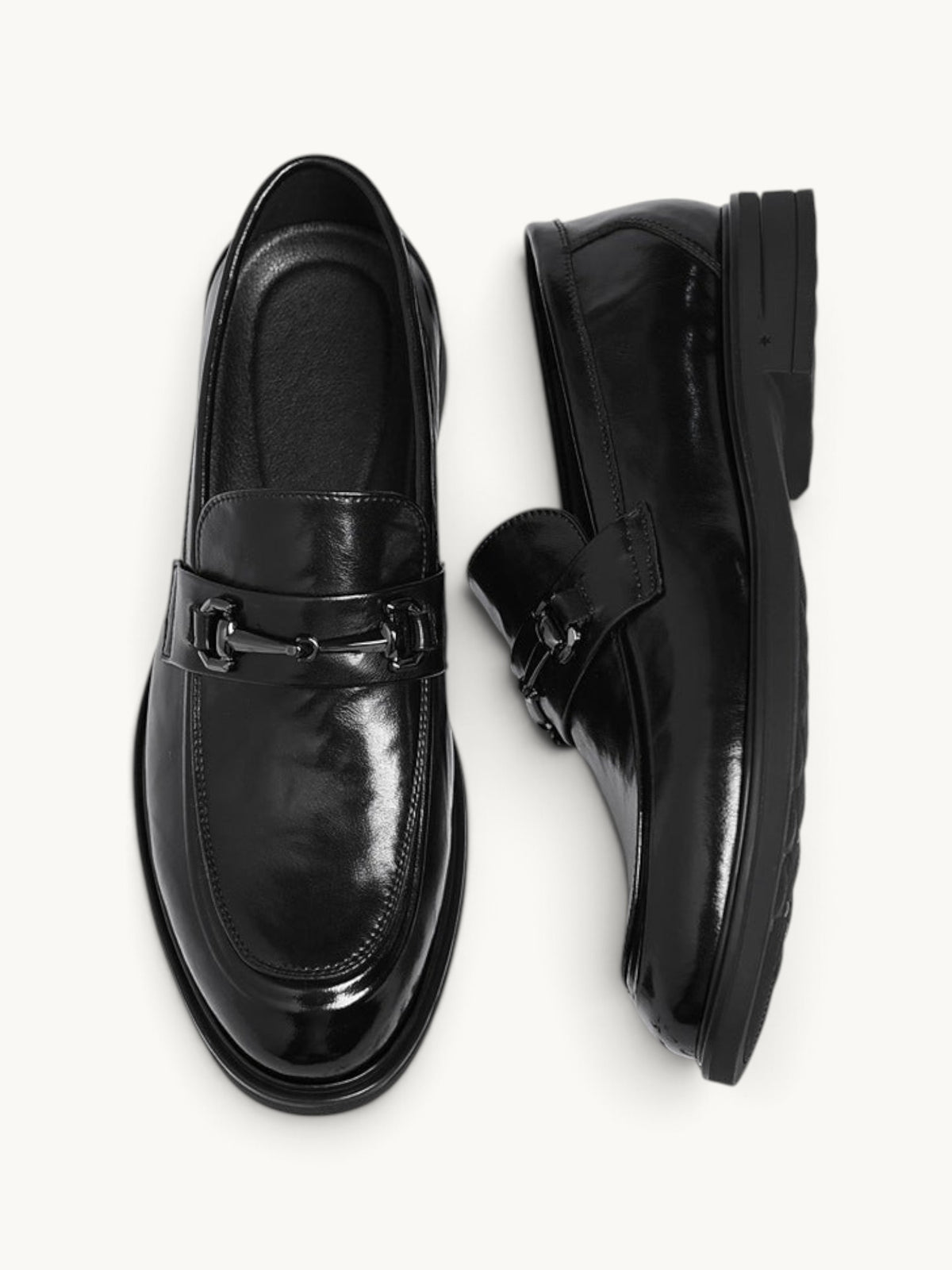 By Old Money black recycled leather loafers with a polished finish and metal bit detail, shown from above.