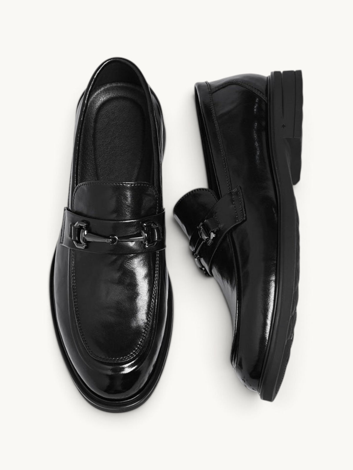 By Old Money black recycled leather loafers with a polished finish and metal bit detail, shown from above.