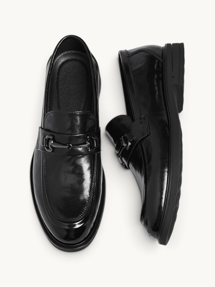 By Old Money black recycled leather loafers with a polished finish and metal bit detail, shown from above.