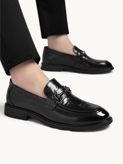 By Old Money black leather loafers with a polished finish and metal bit detail worn with black trousers