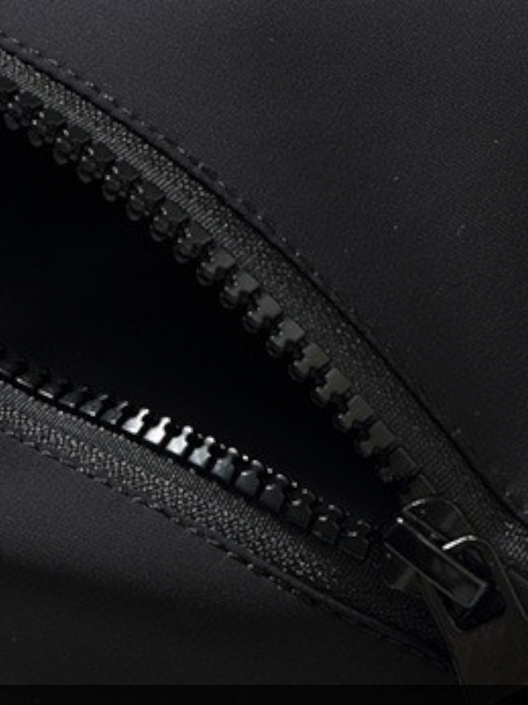 By Old Money black parka featuring a durable zipper closure with a protective buttoned placket detail
