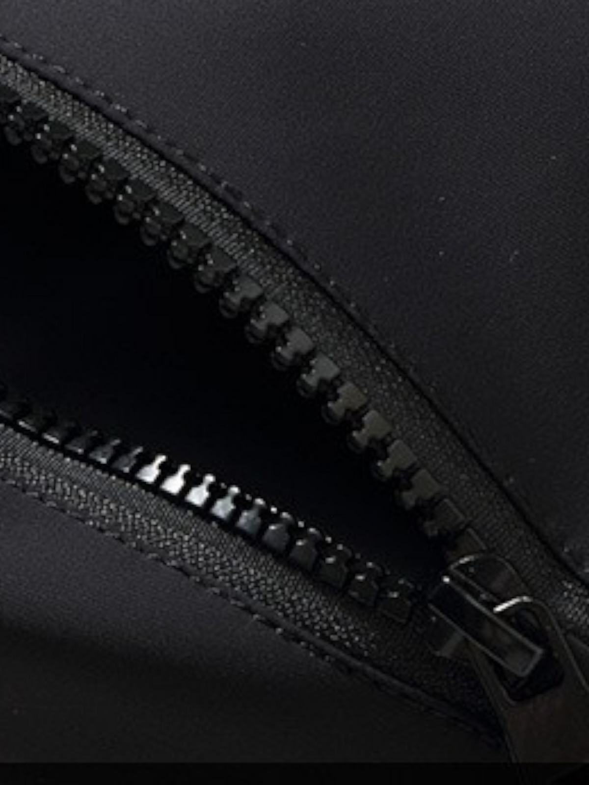 By Old Money black parka featuring a durable zipper closure with a protective buttoned placket detail