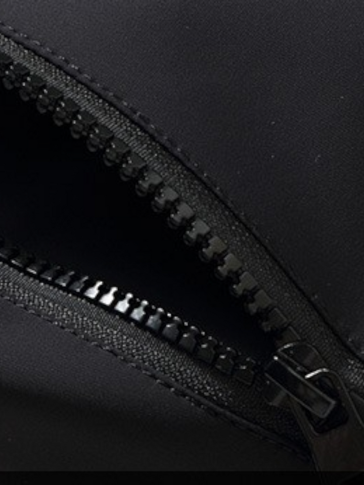 By Old Money black parka featuring a durable zipper closure with a protective buttoned placket detail