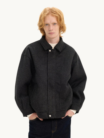 By Old Money charcoal grey double-faced wool boxy jacket with a collar and drop shoulders worn by a male model.