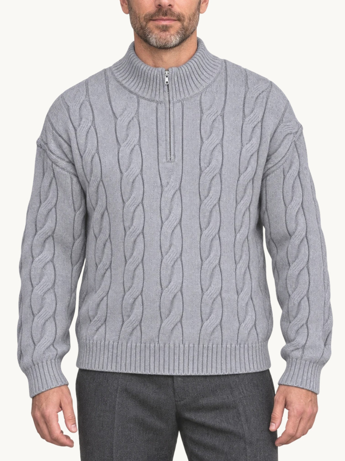 By Old Money grey cable knit half-zip sweater with a high collar worn by a man against a white background.