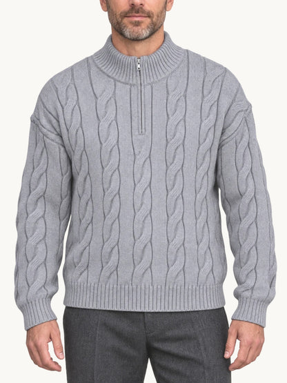 By Old Money grey cable knit half-zip sweater with a high collar worn by a man against a white background.