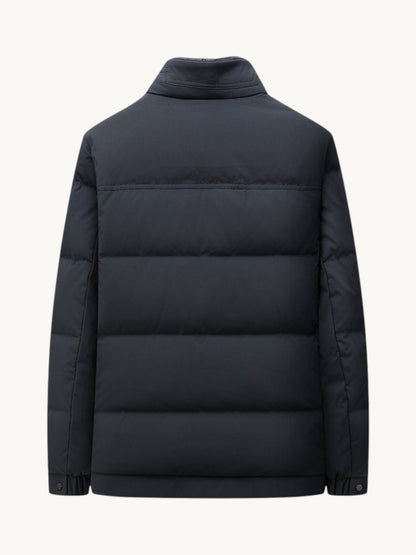 Back view of a By Old Money navy blue quilted winter puffer jacket with a high collar and straight cut