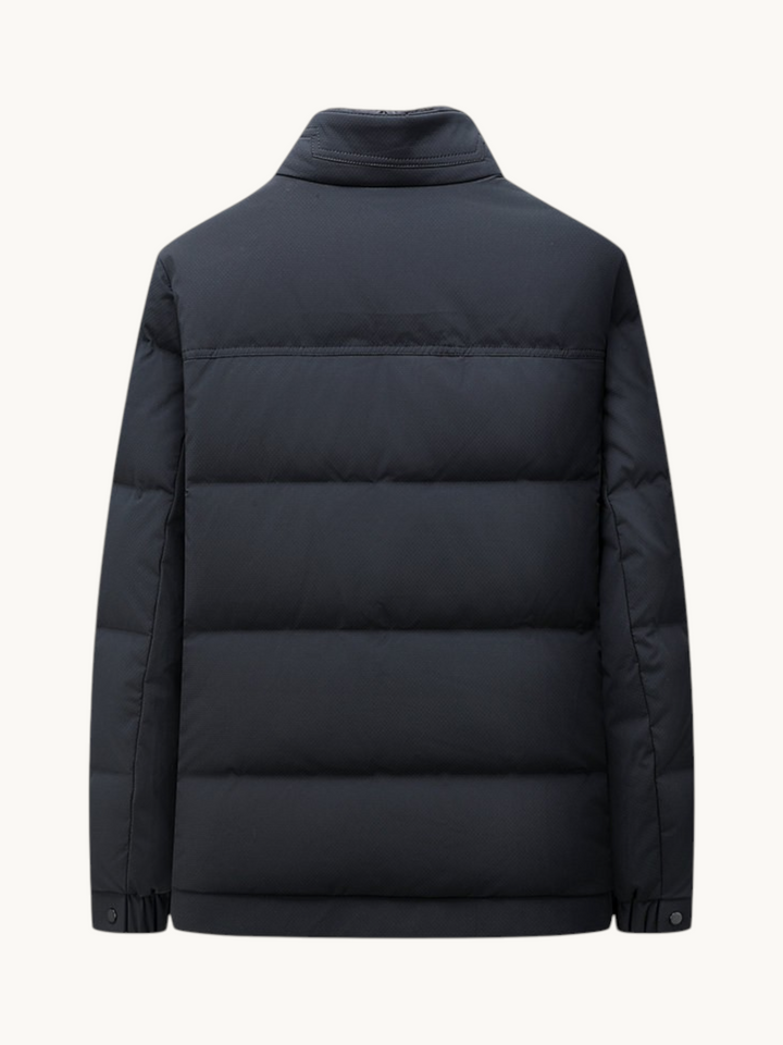 Back view of a By Old Money navy blue quilted winter puffer jacket with a high collar and straight cut