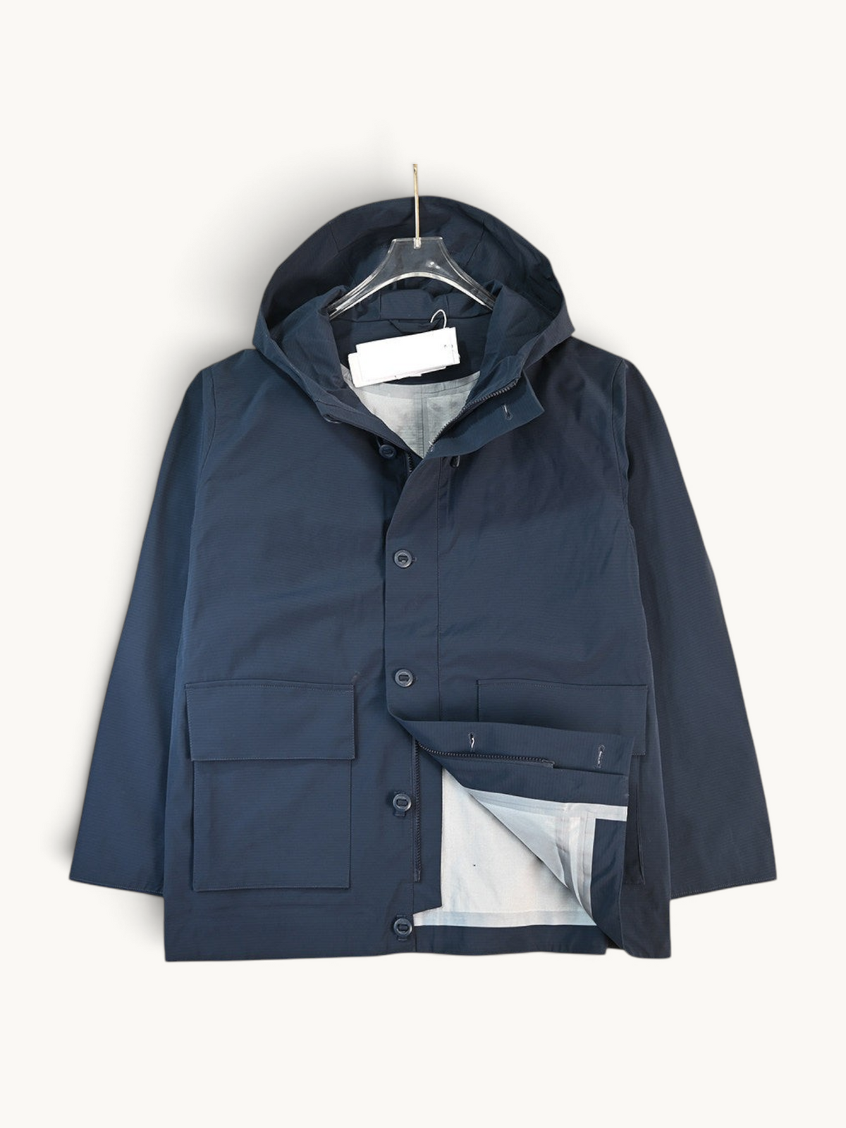 By Old Money navy water-repellent hooded jacket with a matte finish, zip closure, snap buttons, and large flap pockets.