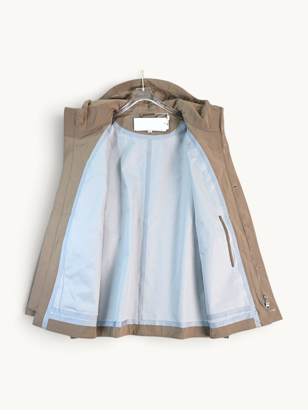 By Old Money water-repellent hooded jacket in beige with a matte finish, drawstring hood, and interior lining.