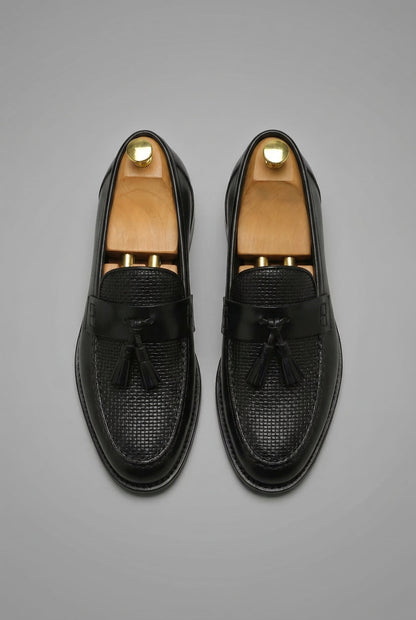 Mocassins à pampilles noirs vus du dessus, empeigne au motif tressé