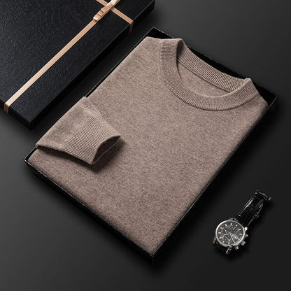 Pull col rond beige plié dans une boîte, col et poignet côtelés