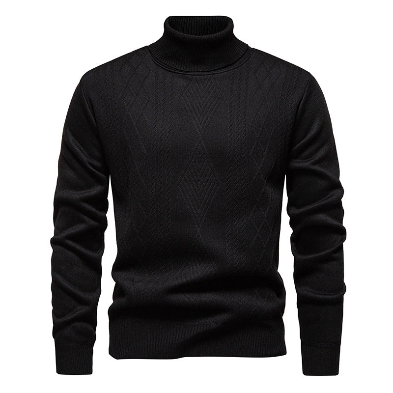 Pull col roulé à losanges, coloris noir, présenté à plat