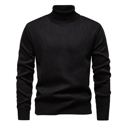 Pull col roulé à losanges, coloris noir, présenté à plat