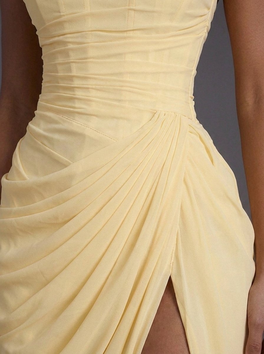 Détail du bustier baleiné et du drapé croisé sur la hanche, jaune pâle