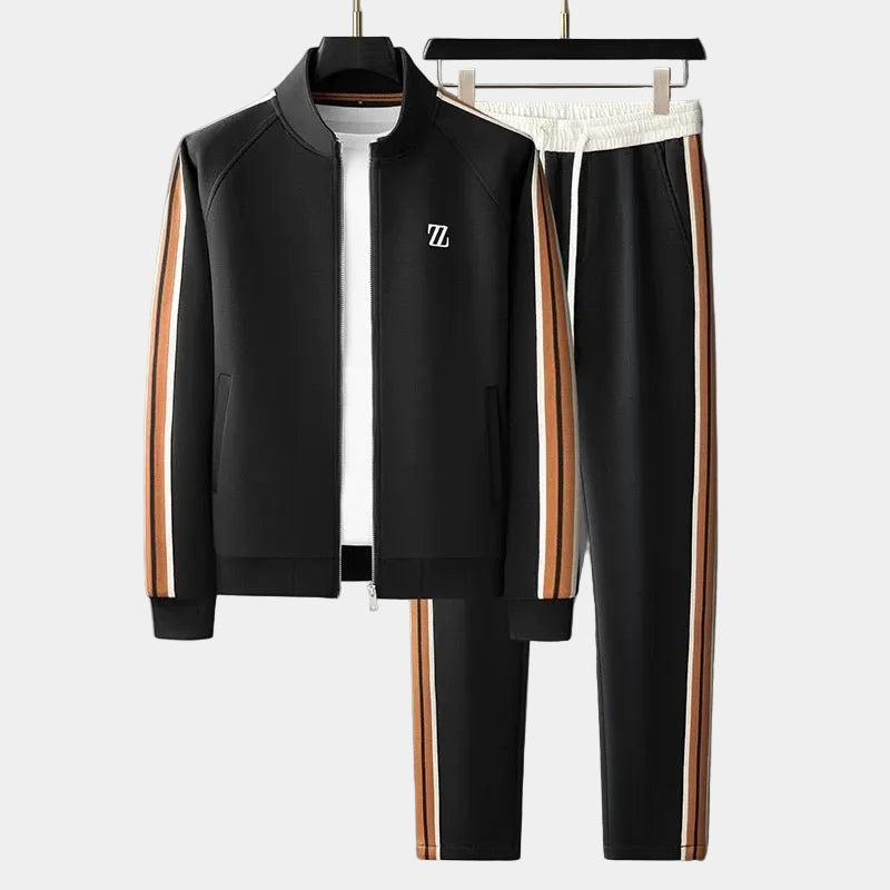 Survêtement noir : veste zippée à col montant et pantalon à bandes orange et blanches
