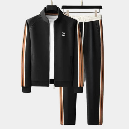 Survêtement noir : veste zippée à col montant et pantalon à bandes orange et blanches