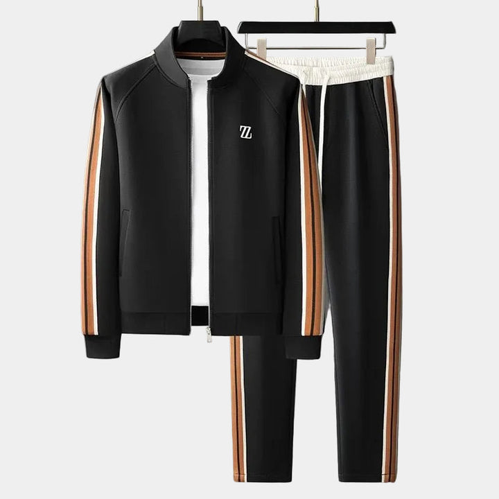 Survêtement noir : veste zippée à col montant et pantalon à bandes orange et blanches