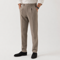 Taupe pleated front trousers with turn-ups worn on model with white shirt