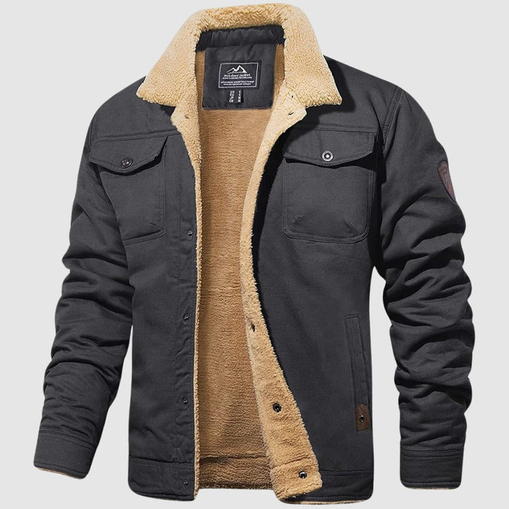 Veste en coton gris foncé doublée sherpa, col en peau lainée et écusson sur la manche