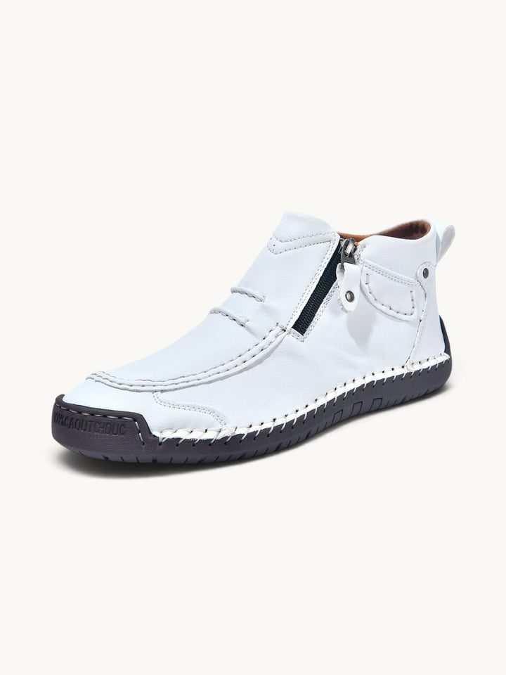Bottine en cuir blanc avec fermeture éclair et semelle noire contrastée